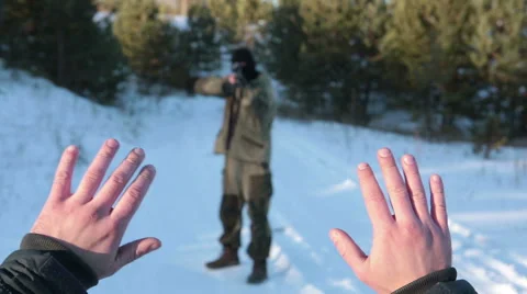 Terrorist kills a hostage in a forest in winter Stock Footage 45319873