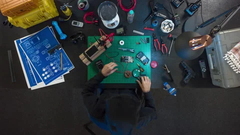 The terrorist makes a bomb in a dark basement. View of the table from above. Stock Footage 97930182