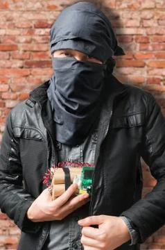 Terrorist puts dynamite bomb in jacket. Terrorism concept. Stock Photos