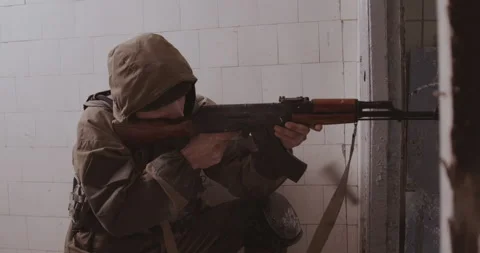 The terrorist shoots from the AK-47 automatic machine. Stock Footage 153625704