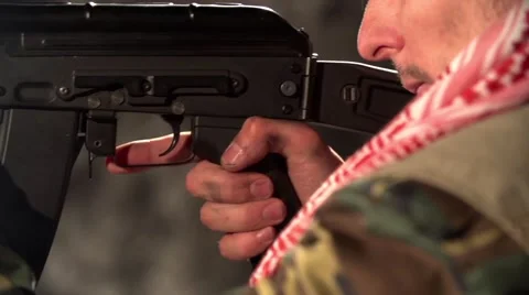 The terrorist shoots from an automatic rifle in slow-motion Stock Footage 58216638
