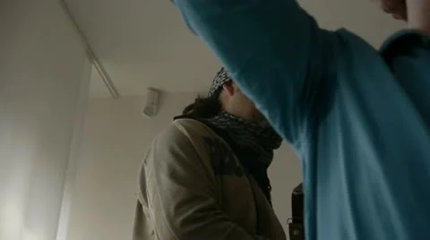 Terrorist walking along hostages Stock Footage