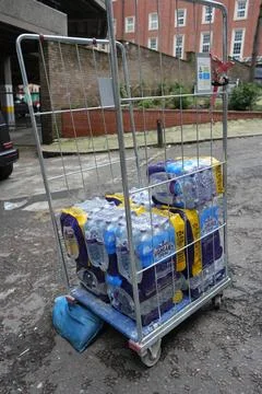 Tesco Roll Cage With Highland Spring Bottled Water On Street, Nottingham, Stock Photos