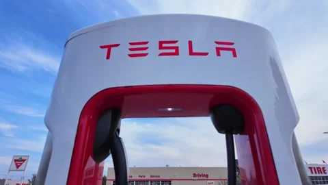 Tesla charging station in a spacious parking lot outside a Canadian Tire st.. Stock Footage 287142970