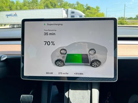 A Tesla computer screen showing that this Tesla is charging it's batteries wh 스톡 사진