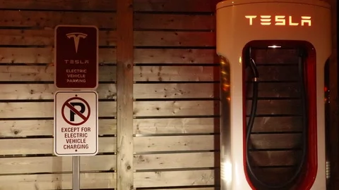 Tesla Electric Vehicle Charging Station at Night Stock Footage 126986012