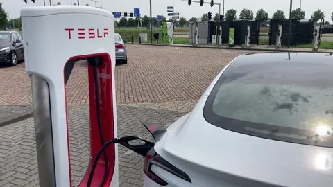 Tesla EV charging at Tesla station close 動画素材 313420261