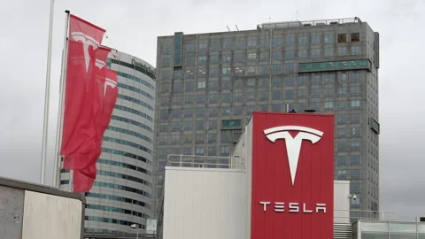 Tesla flag and logo at Tesla headquarters in Amsterdam, Netherlands. Stock Footage 258279474
