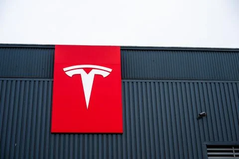 Tesla logo on the facade of a large workshop Stock Photos