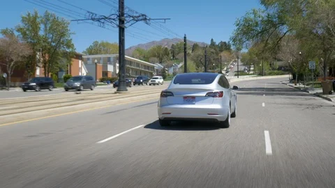 Tesla Model 3 - Driving - Rear 3 quarter angle around corners. Stock-Footage 93422110
