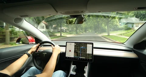 Tesla Model 3 Driving through Suburban Neighborhood Stock Footage 91332929