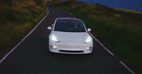 Tesla Model 3 Electric Car Driving at Sunset Stock Footage 89524357