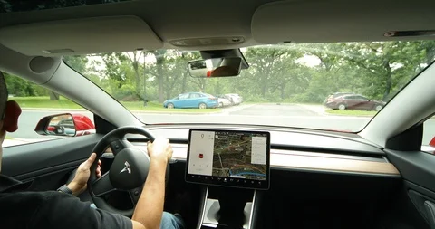 Tesla Model 3 Pulling into Traffic Along Minnehaha Falls Stock Footage 91355967