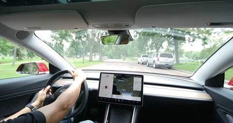 Tesla Model 3 Pulling into Traffic Around Lake Harriet Video stock 92689011