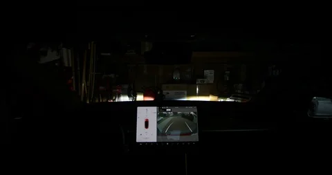 Tesla Model 3 Pulls out of a Garage Stock Footage 93312354
