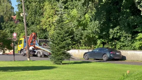 A Tesla Model S is being prepared to tow away in Europe Stock Footage 248380658