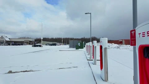 Tesla Superchargers standing in empty parking lot of Meijer retail shop in Stock-Footage 333550239