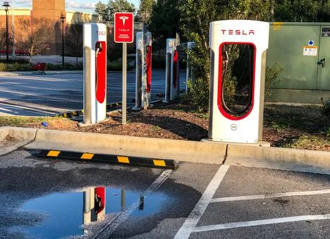 Tesla Supercharging Location with Nice Reflection. Stock Photos