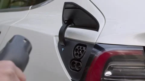 Tesla unplugin from a charger. Stock Footage 249171155