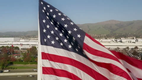 Tesla zero emission concept world famous company, USA Flag waving, Tesla factory Video stock 168149344