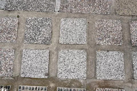 Tessellated pathway made of square textured concrete tiles Fotos de archivo