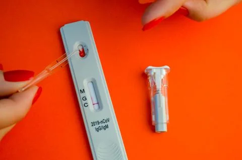Test for coronavirus on an orange background. on a matte background a sensiti Stock Photos