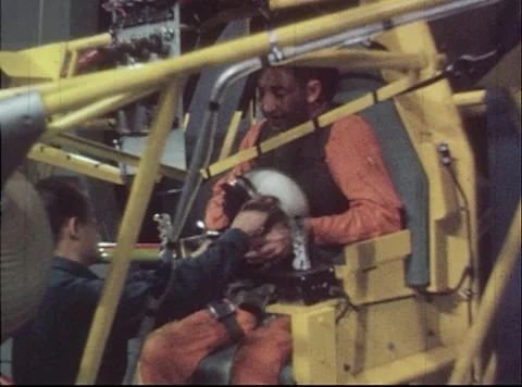 Test engineer securing pilot into Multi-Axis Space Test Facility  Stock Footage 262445228