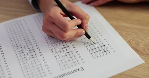 Test exam concept and writing answer in pencil on paper Stock Footage 263156454