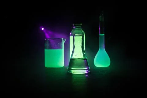 Test glass flask with solution in research laboratory. Science and medical ba Stock Photos