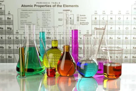 Test glass flasks and tubes with colored solutions on the periodic table o... Stock Photos
