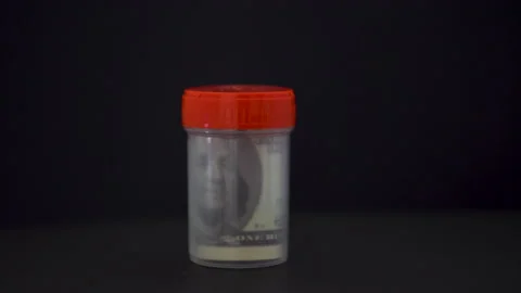 Test jar and dollar 4K Stock Footage 154514852