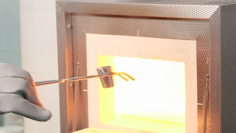Test on a laboratory muffle in which a sample is calcined in a platinum cruci Stock-Footage 152674242