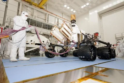 A test operator in clean-room garb holds umbilical cables for NASA's Mars r.. Stock Photos