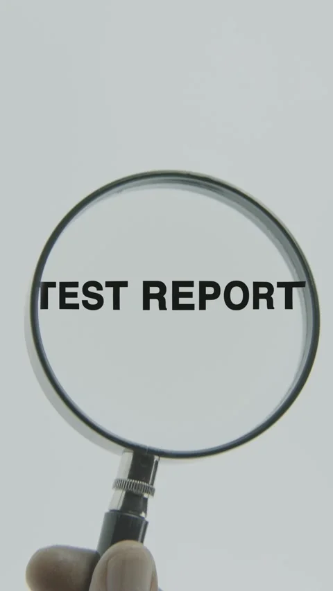 Test Report text or word highlighted by a magnifying glass in a hand Stock Footage 303524003