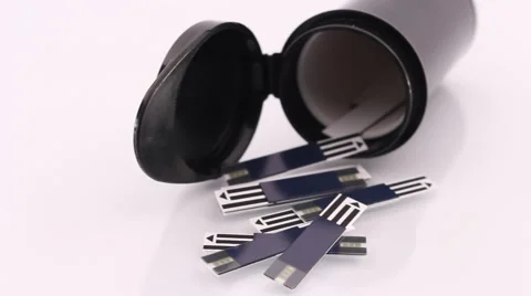 Test Strips Used by Diabetes Lying on a White Shiny Table Pan Stock Footage 56479022