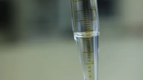 A test tube with 2 ml of transparent solution is shaken Stock Footage 75845296