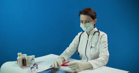A test tube with a blood sample, a microbiologist in white surgical gloves Stock Footage 130400330