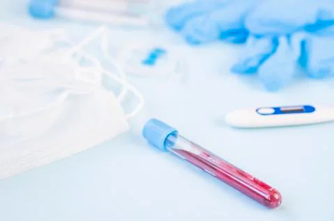 Test tube for taking a blood sample for a virus or flu.  Mask, gloves, thermo Stock Photos