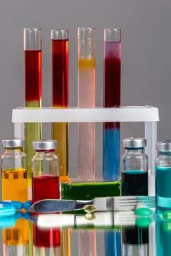 Test tubes and bottles with various colored liquids. Stock Photos