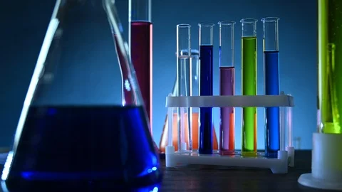 Test tubes and flasks with colored liquids stand on a table in a laboratory Stock Footage 121521299