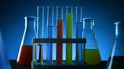 Test tubes and flasks with colored liquids stand on a table in a laboratory Stock Footage 121521430
