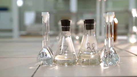 Test tubes and flasks with samples of water and raw materials in laboratories Stock Footage