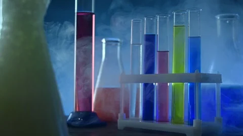 Test tubes and flasks stand in the laboratory in a smoky background Stock Footage 121521196