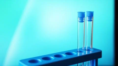 Test-tubes on a blue stand against blue background Stock Photos