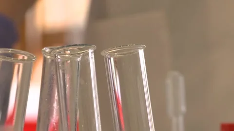 Test Tubes in Foreground with Blurred Busy Laboratory Background Stock Footage 296846029