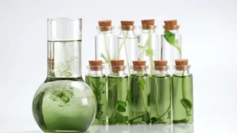 Test tubes with micro greens and reagent Chlorophyll extract poured in water Stock Footage 169753746