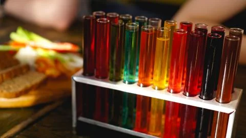 Test tubes with multi-colored liquid. Alcohol in test tubes dark bar Stock Photos