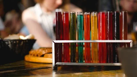 Test tubes with multi-colored liquid. Alcohol in test tubes dark bar Stock Photos