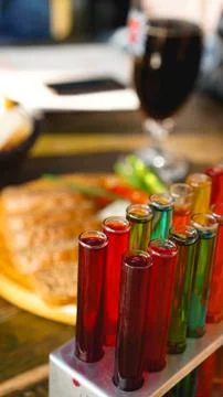 Test tubes with multi-colored liquid. Alcohol in test tubes dark bar Stock Photos