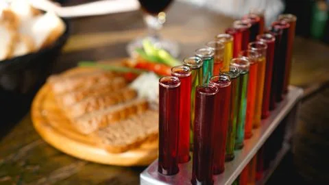 Test tubes with multi-colored liquid. Alcohol in test tubes dark bar Stock Photos